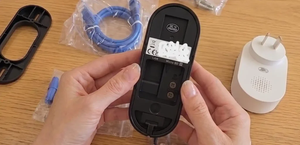 Close-up of the Reolink doorbell back panel showing the security camera with local storage microSD slot.